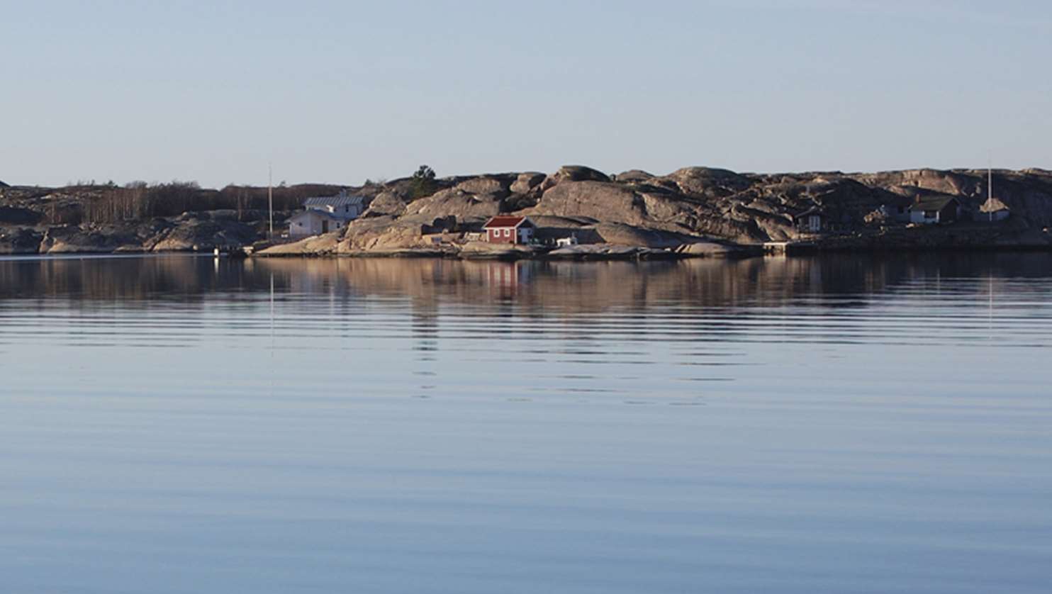 Flera hus på bergsklippor vid havet.